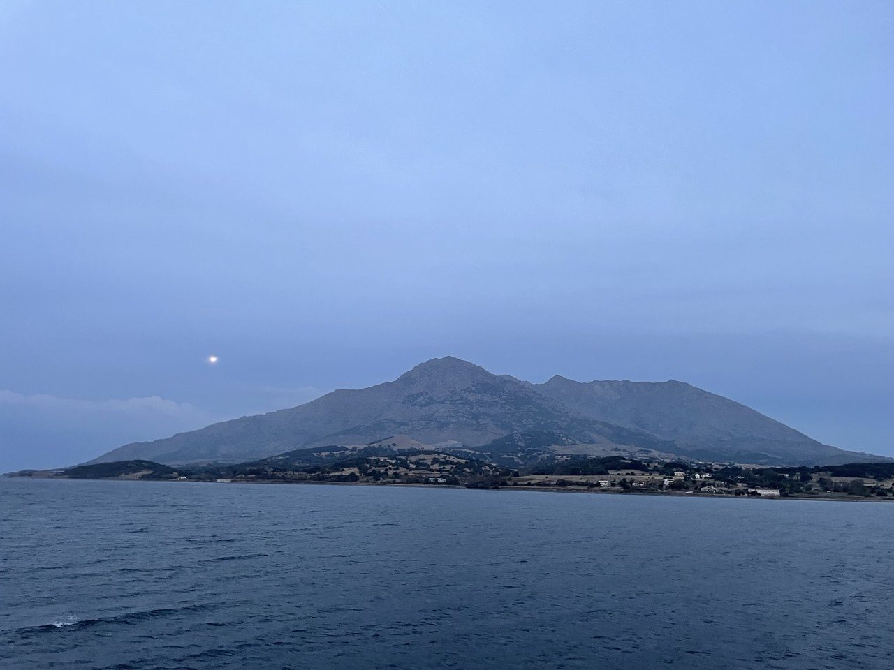 Samothrace’s mountain rising from the sea at dusk, with the moon beside it